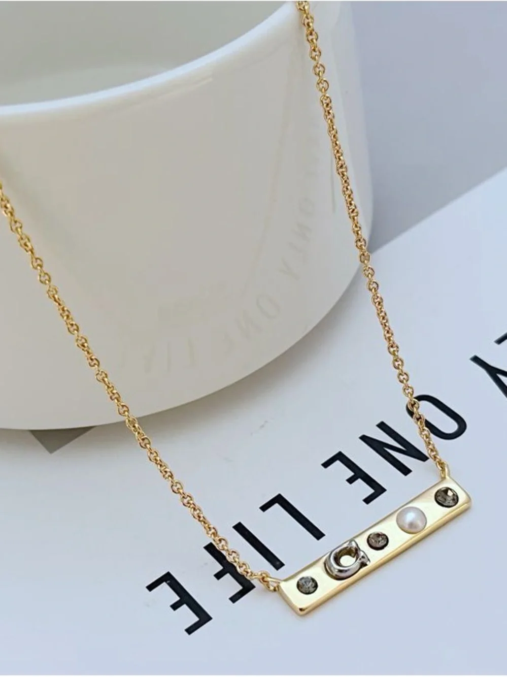 Coach Gold-Tone Bar Necklace with Crystal and Pearl Accents - Picture 2 of 5